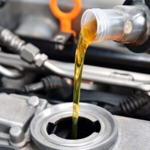 Close up of a person putting new oil into a vehicle