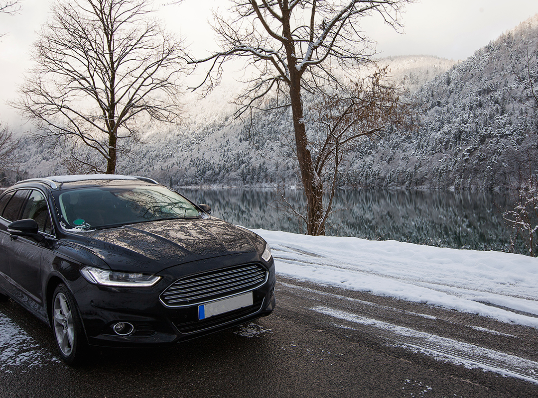 car driving on snowy winter road